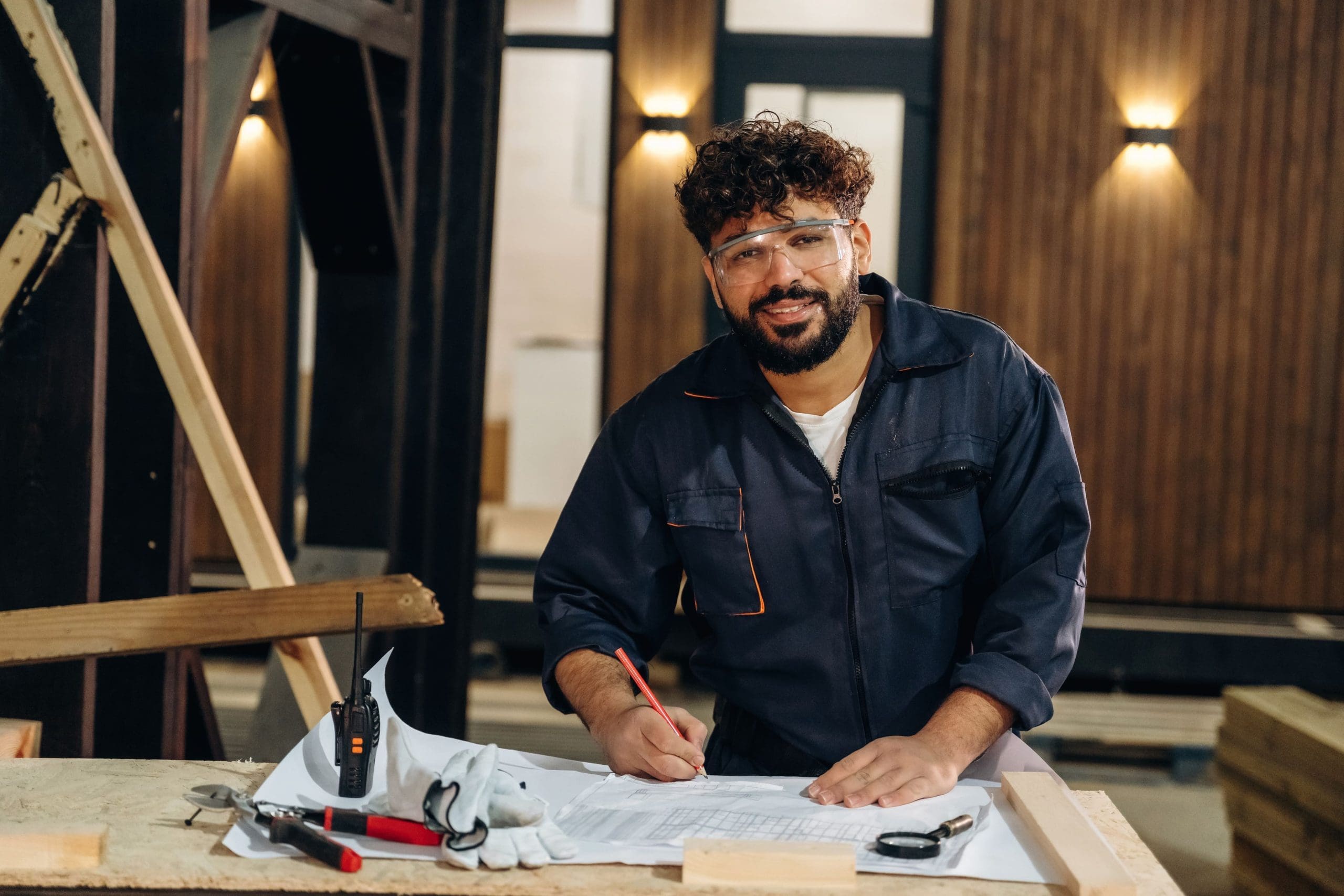 Portrait of a male carpenter posing in a woodworking workshop